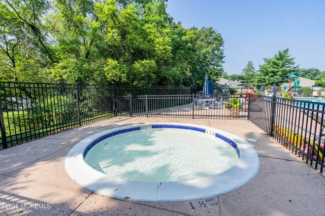 a small pool with a table and chairs