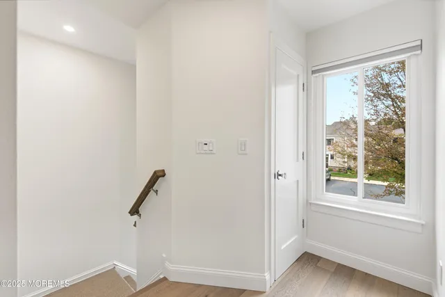 a view of room with window and wooden floor