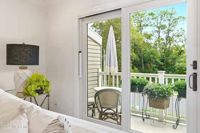a balcony with table and chairs