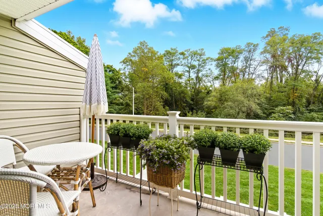 a view of a chair and tables in the balcony