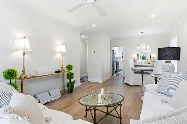 a living room with furniture and a chandelier