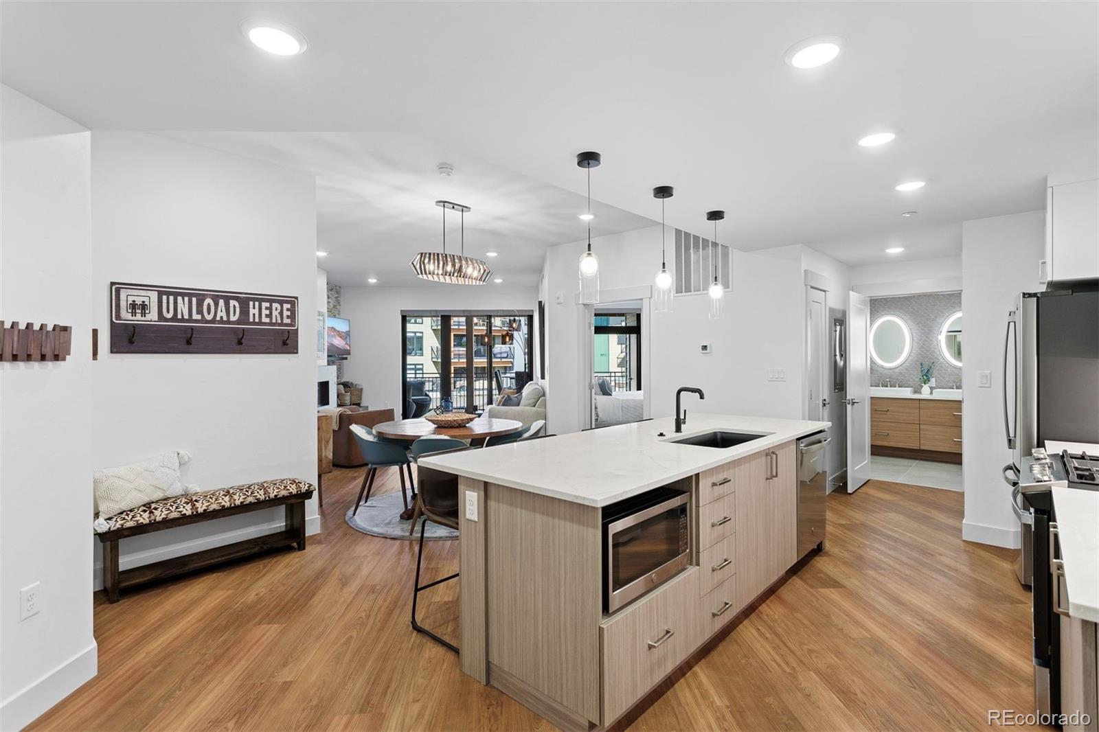 144 Ski Idlewild Road, Unit 3201 Winter Park, CO 80482 - Photo 1 of 39 a large kitchen with stainless steel appliances a lot of counter space and a wooden floor
