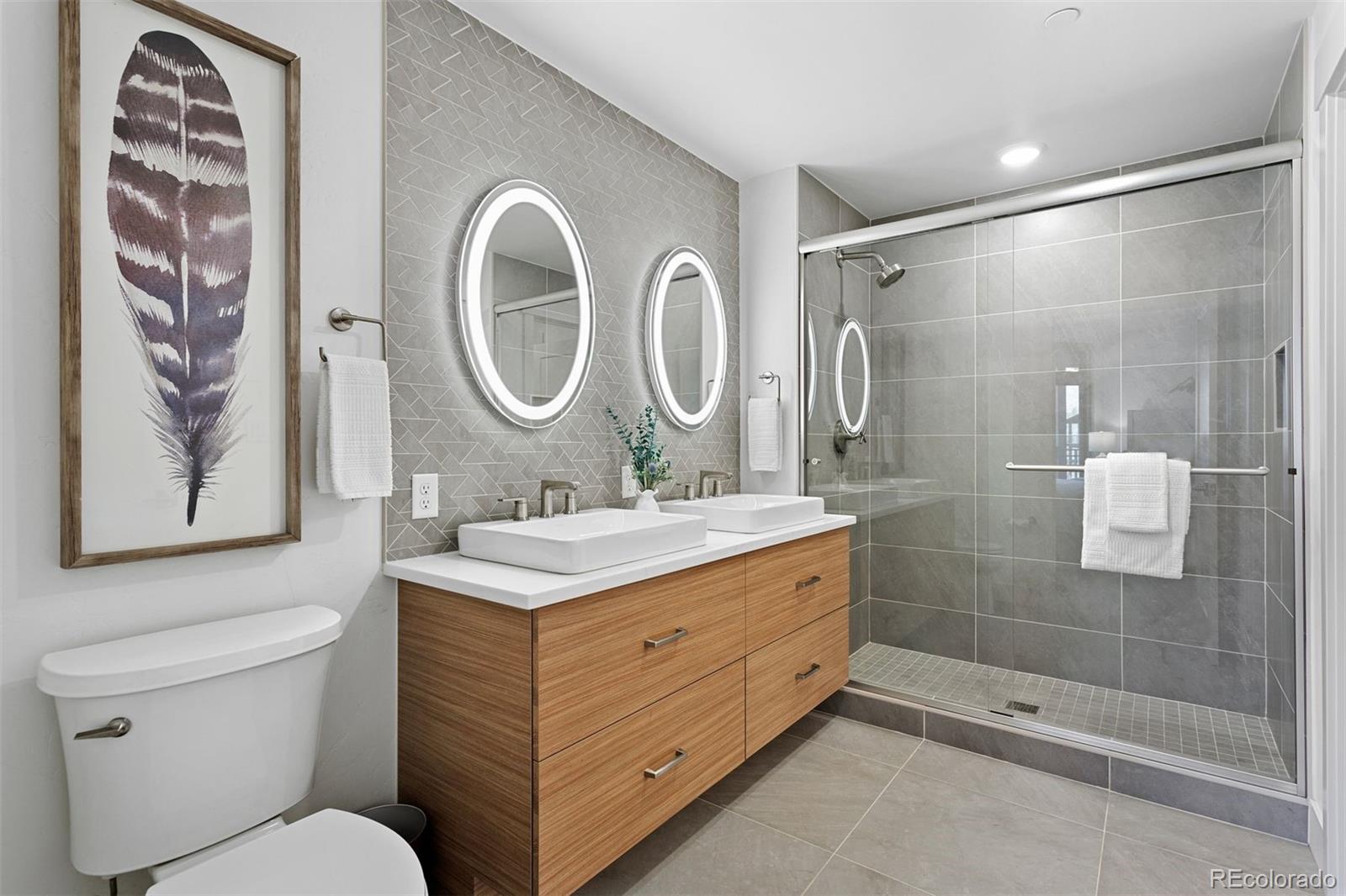 144 Ski Idlewild Road, Unit 3201 Winter Park, CO 80482 - Photo 22 of 39 a bathroom with a granite countertop sink a toilet a mirror and shower