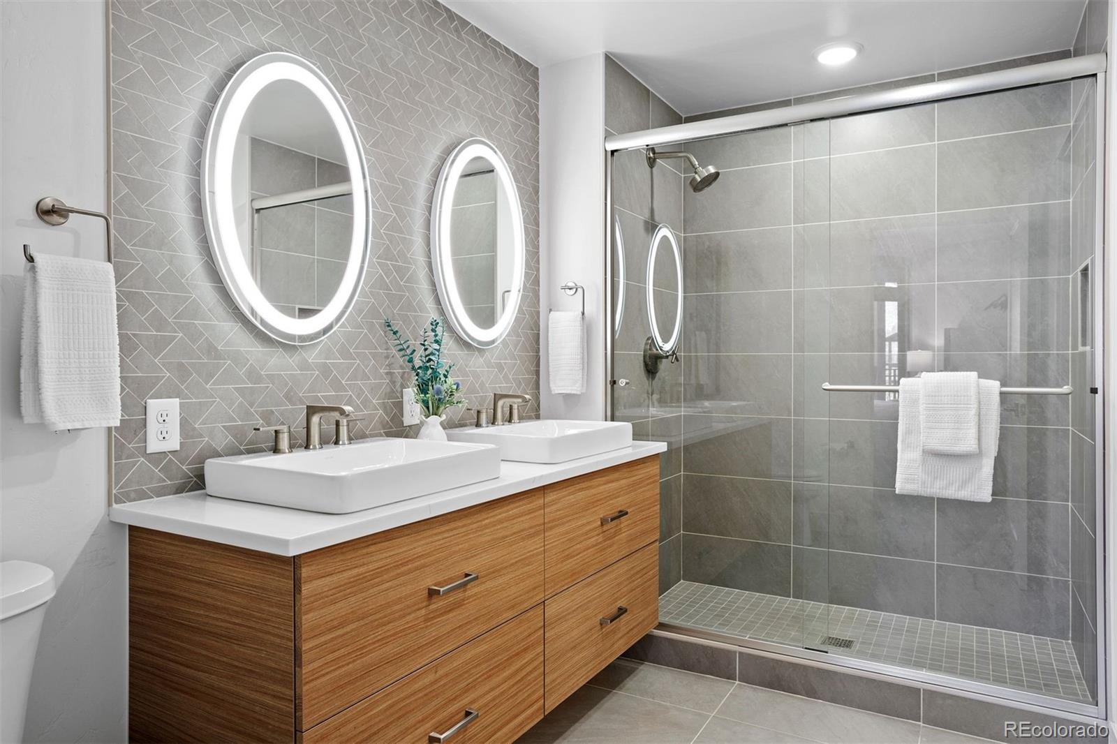 144 Ski Idlewild Road, Unit 3201 Winter Park, CO 80482 - Photo 23 of 39 a bathroom with a double vanity sink mirror and shower