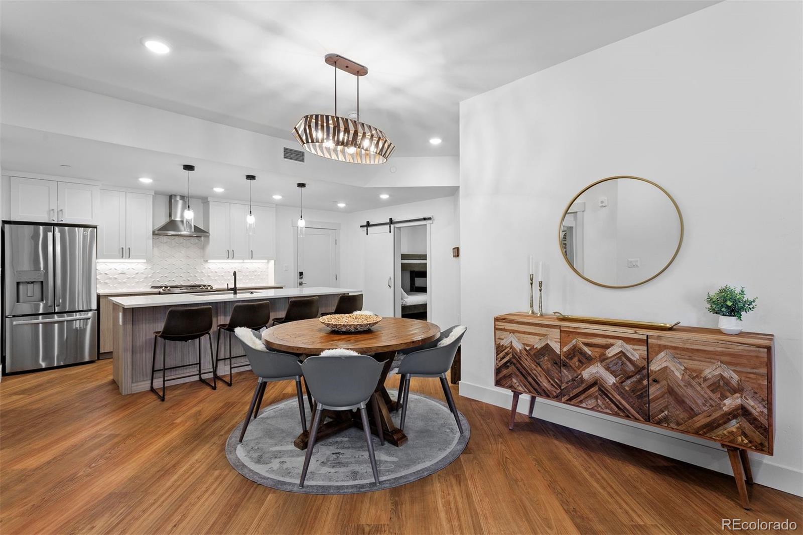 144 Ski Idlewild Road, Unit 3201 Winter Park, CO 80482 - Photo 6 of 39 a view of a dining room with furniture a chandelier and wooden floor
