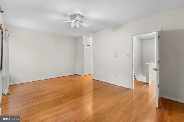 a view of an empty room with wooden floor