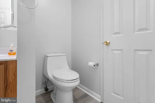 a white toilet sitting next to a shower