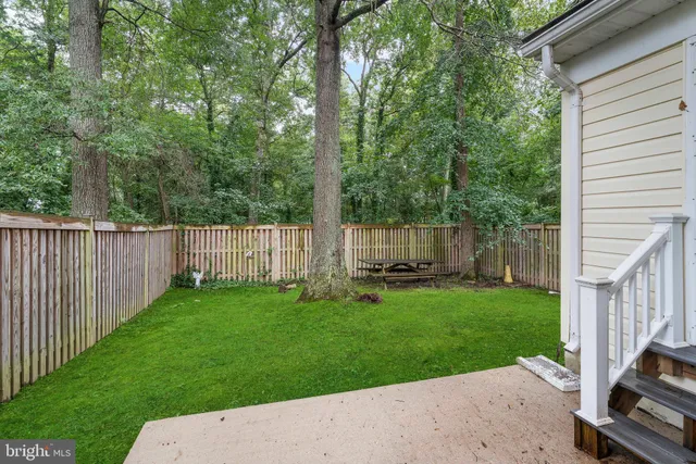 a view of a backyard with wooden fence