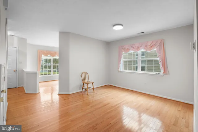 a view of a livingroom with wooden floor and a window