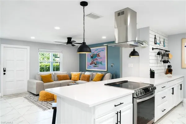 a kitchen with a sink a stove and a dining table