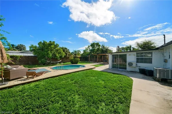 a view of a backyard with sitting area