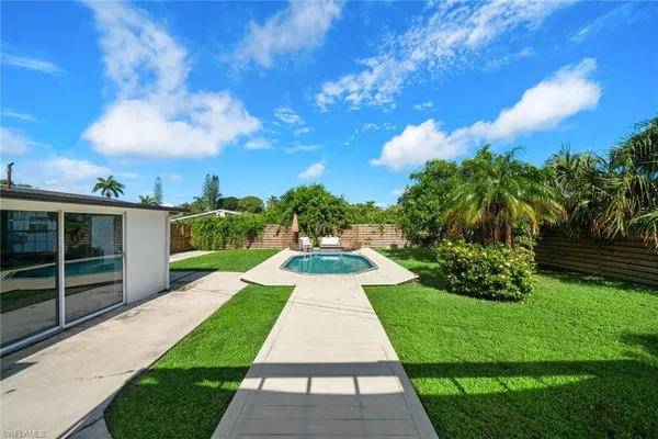 a view of a pathway with a yard