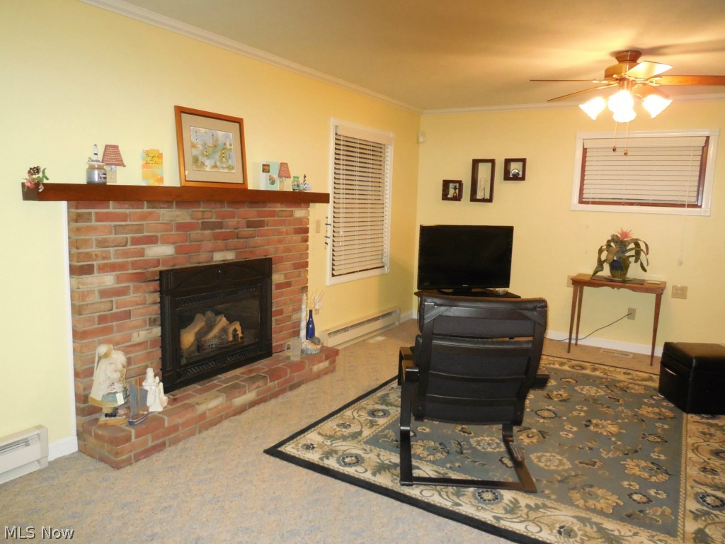 264 Miles Road Chagrin Falls, OH 44022 - Photo 7 of 11 Large family room with brick wood burning fireplace, ceiling fan, wall to wall carpeting.