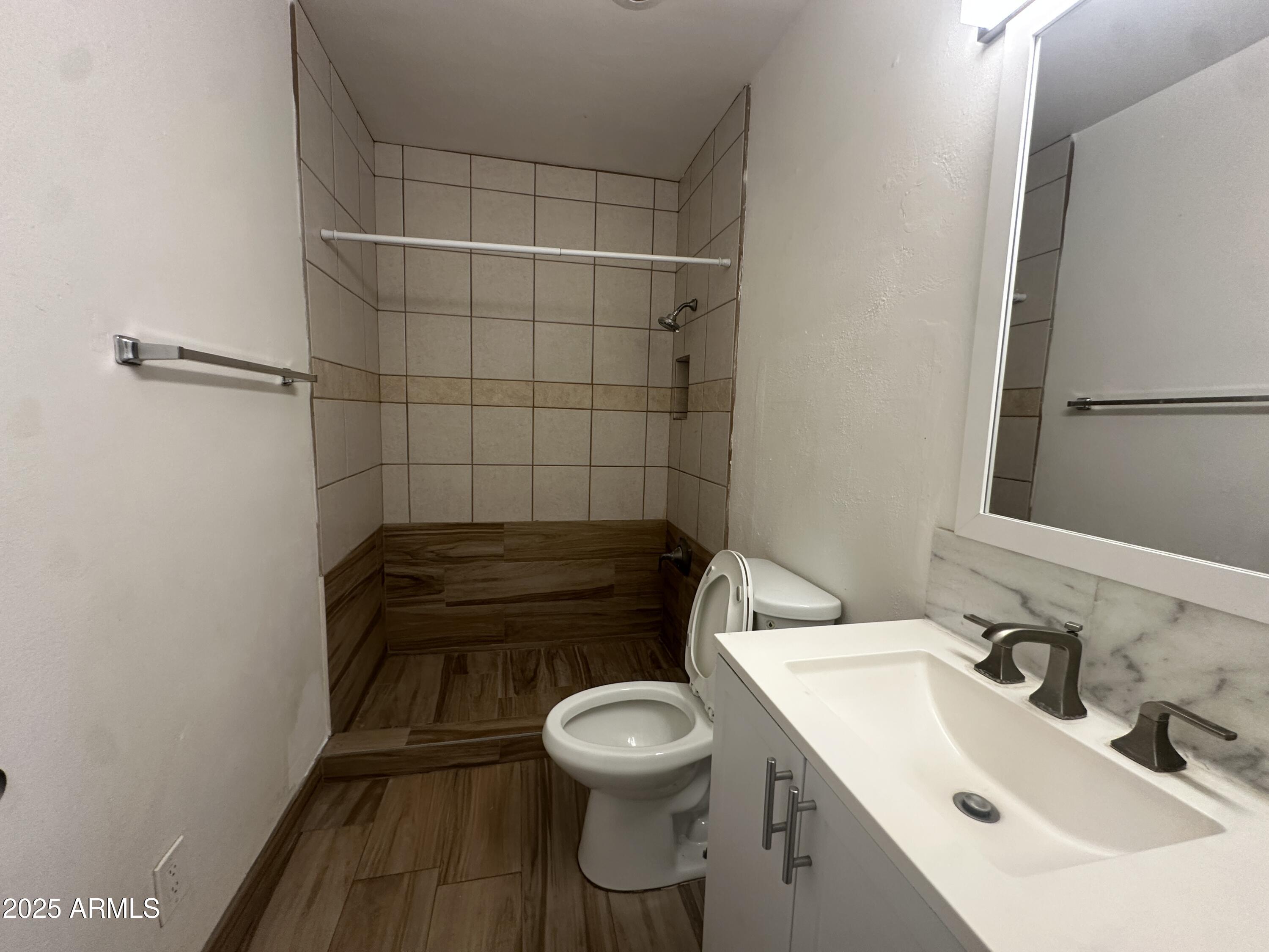 1340 East Hall Street Tempe, AZ 85281 - Photo 18 of 21 a bathroom with a sink a toilet and a mirror