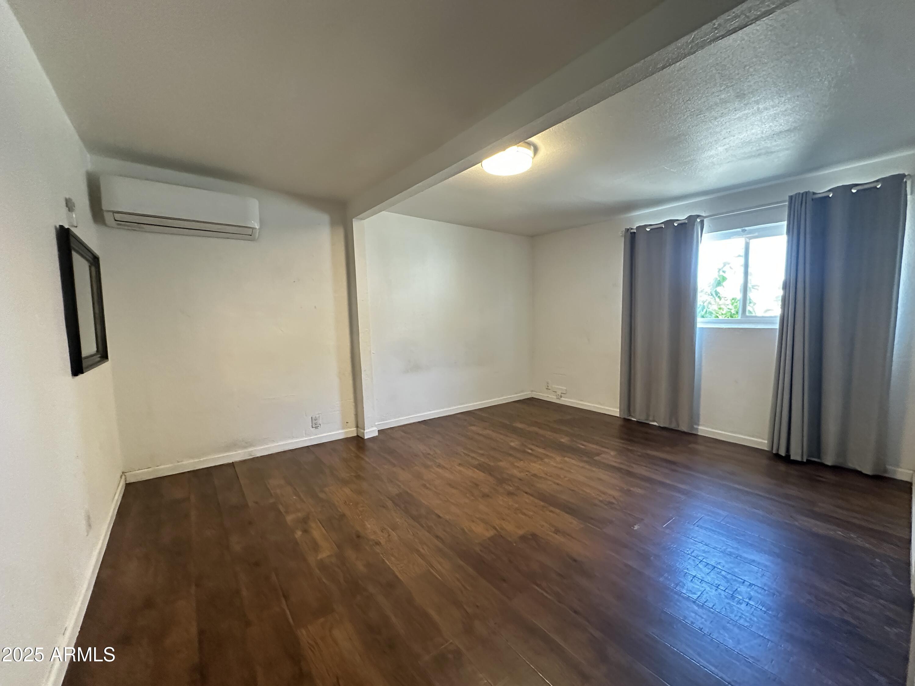 1340 East Hall Street Tempe, AZ 85281 - Photo 7 of 21 an empty room with wooden floor and windows