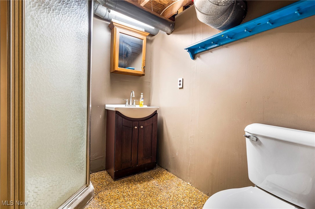 4870 15th Street Southwest Canton, OH 44710 - Photo 21 of 36 Bathroom featuring vanity, a stall shower, and nature stone floor