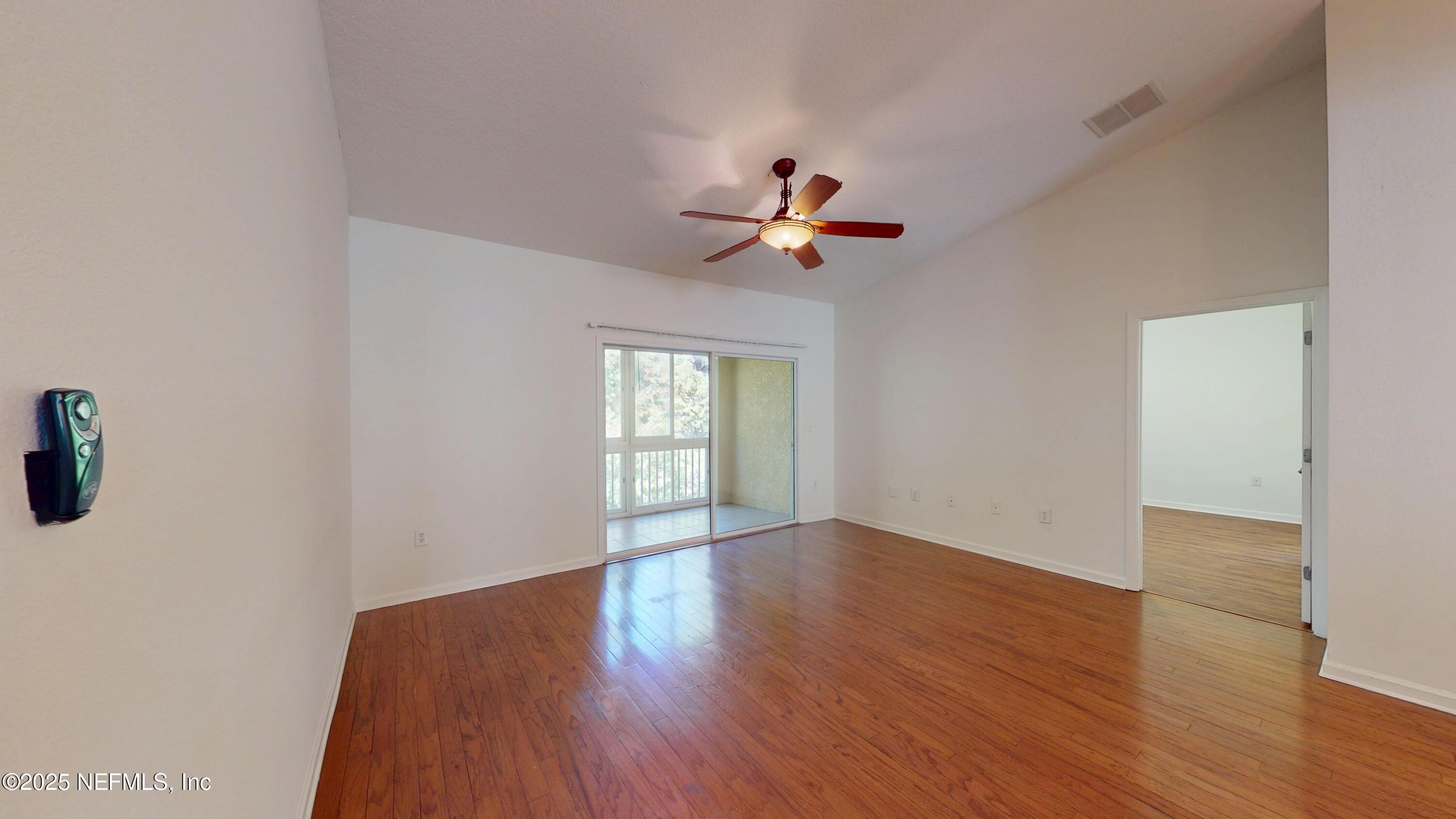 5663 Greenland Road, Unit 1004 Jacksonville, FL 32258 - Photo 11 of 35 a view of a livingroom with a hardwood floor and a ceiling fan