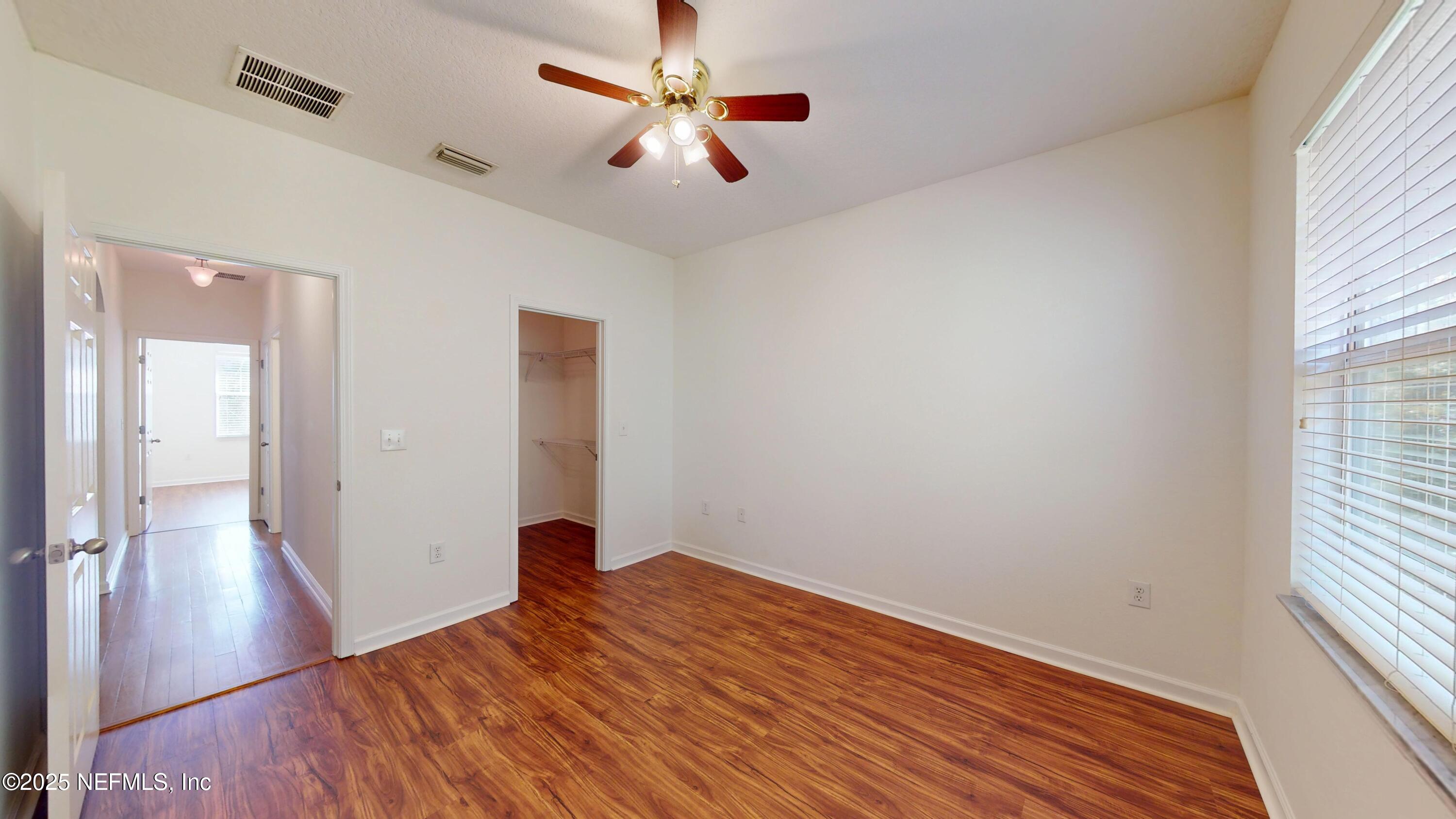 5663 Greenland Road, Unit 1004 Jacksonville, FL 32258 - Photo 13 of 35 wooden floor in an empty room with a window