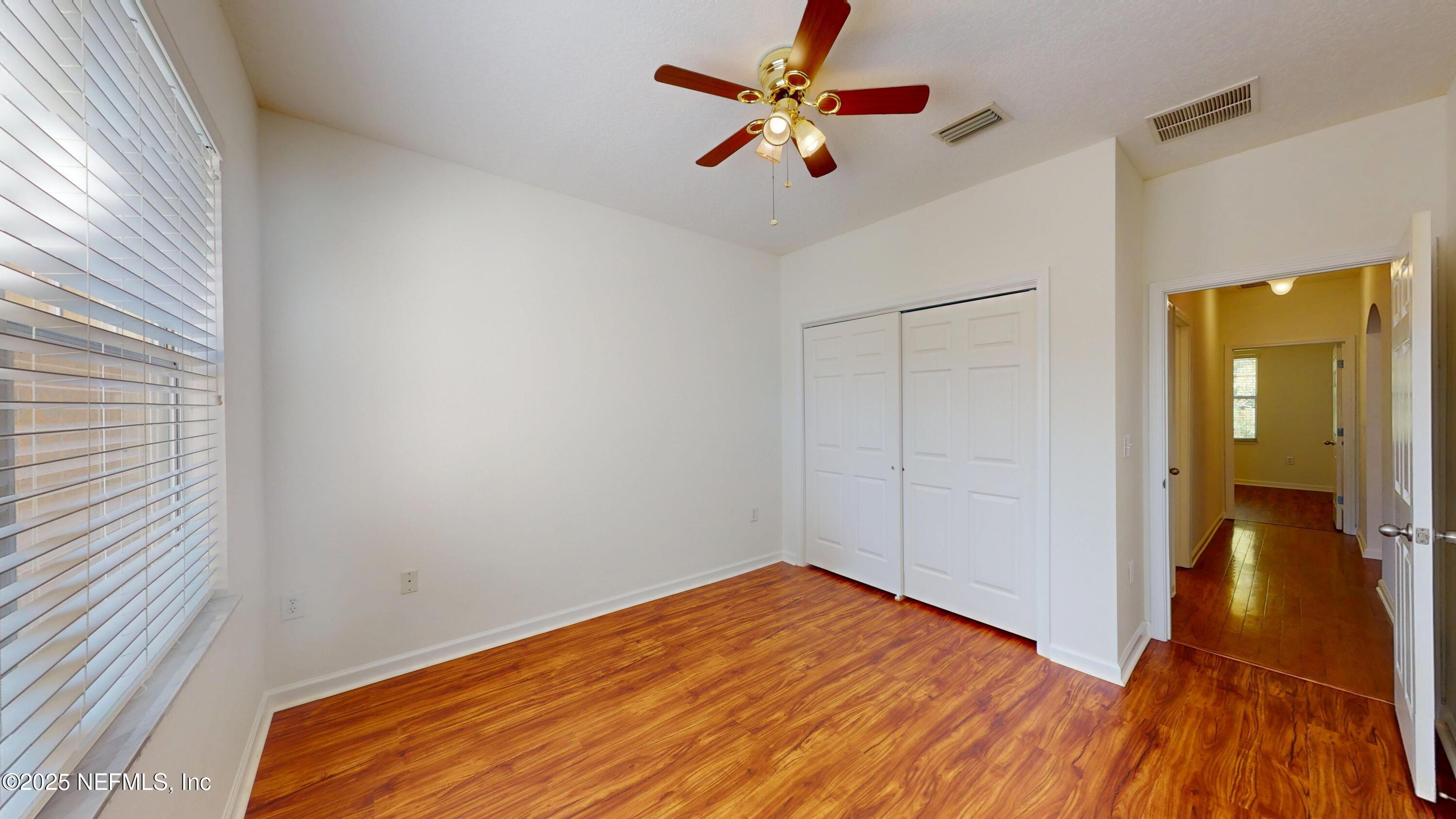 5663 Greenland Road, Unit 1004 Jacksonville, FL 32258 - Photo 18 of 35 a view of an empty room with wooden floor