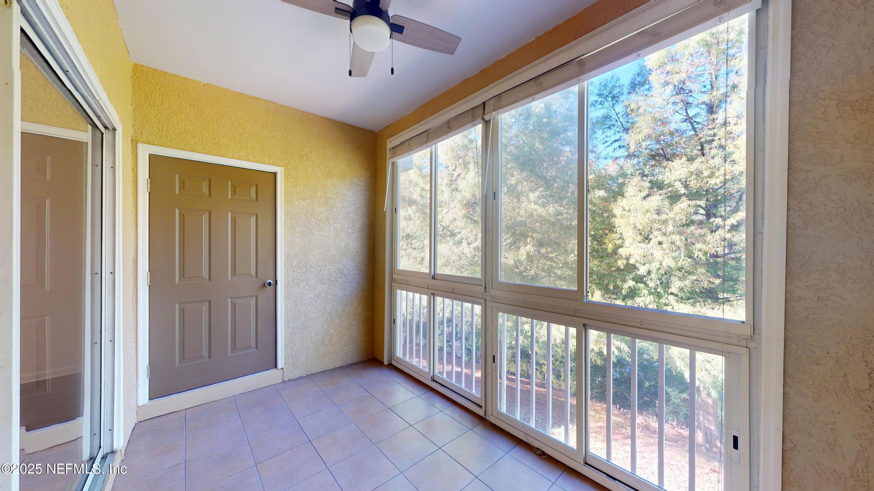 5663 Greenland Road, Unit 1004 Jacksonville, FL 32258 - Photo 26 of 35 a view of a big room with wooden floor a ceiling fan and windows