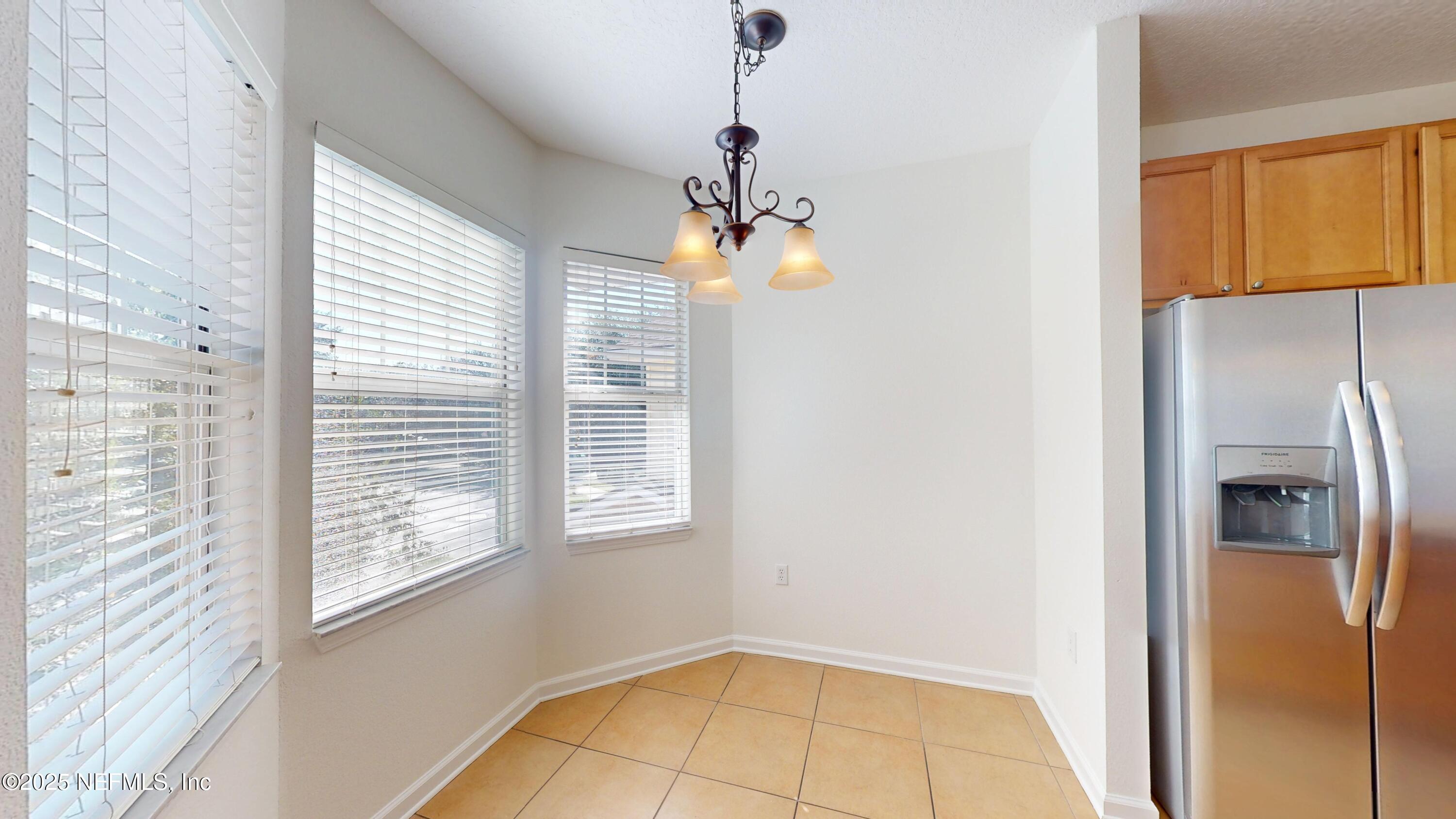 5663 Greenland Road, Unit 1004 Jacksonville, FL 32258 - Photo 7 of 35 a view of a livingroom with a ceiling fan and window