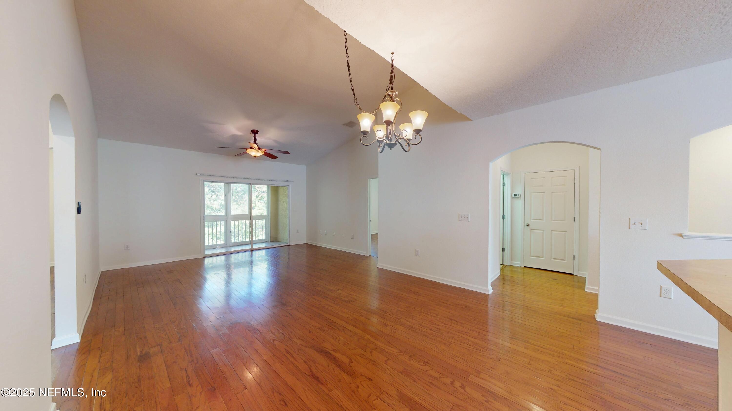 5663 Greenland Road, Unit 1004 Jacksonville, FL 32258 - Photo 10 of 35 a view of an empty room with wooden floor and a window
