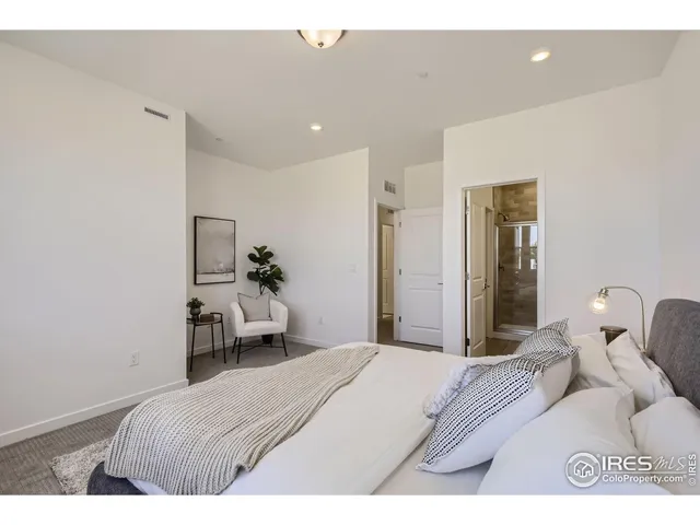 a bedroom with a bed and a mirror