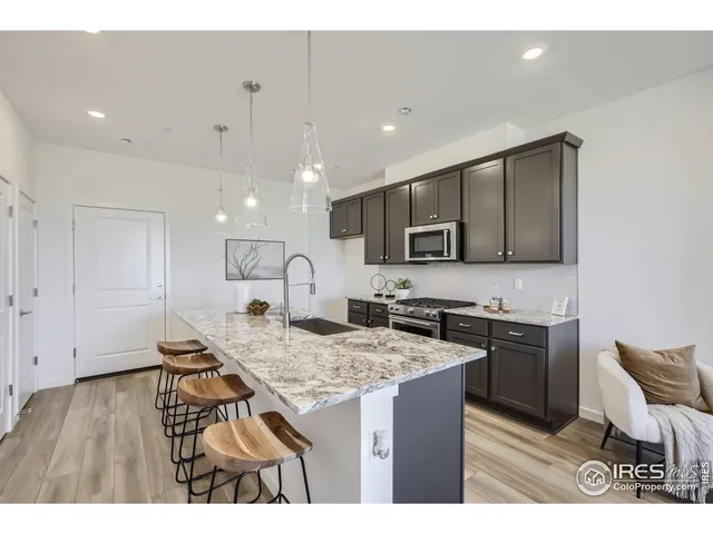 a kitchen with granite countertop kitchen island cabinets and refrigerator
