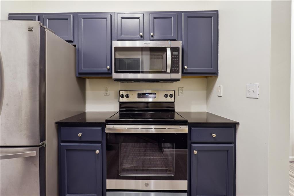 5641 Roswell Road, Unit 103 Atlanta, GA 30342 - Photo 11 of 27 a kitchen with granite countertop cabinets and steel stainless steel appliances