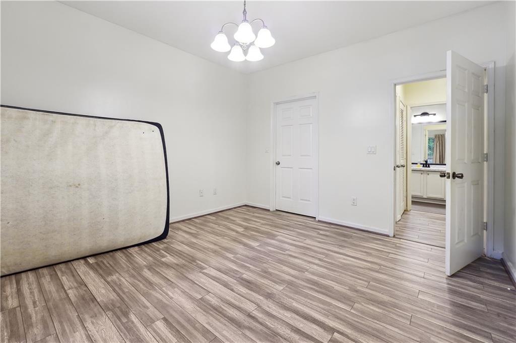 5641 Roswell Road, Unit 103 Atlanta, GA 30342 - Photo 14 of 27 a view of a room with wooden floor and a ceiling fan