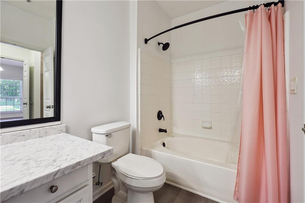 5641 Roswell Road, Unit 103 Atlanta, GA 30342 - Photo 24 of 27 a bathroom with a granite countertop sink toilet and shower