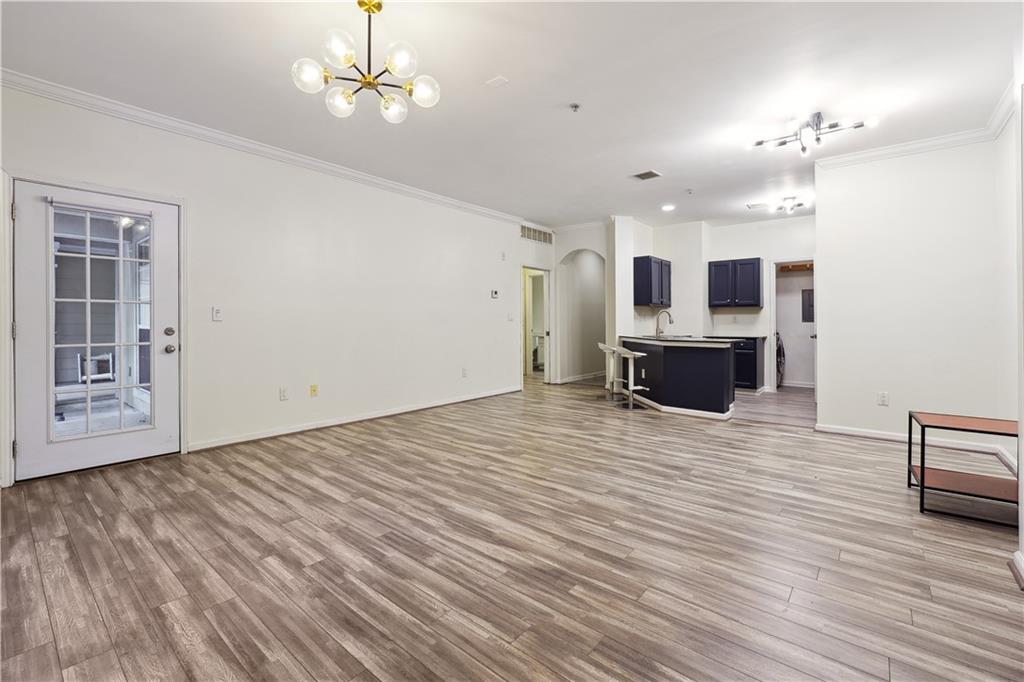 5641 Roswell Road, Unit 103 Atlanta, GA 30342 - Photo 6 of 27 a view of empty room with wooden floor and fan