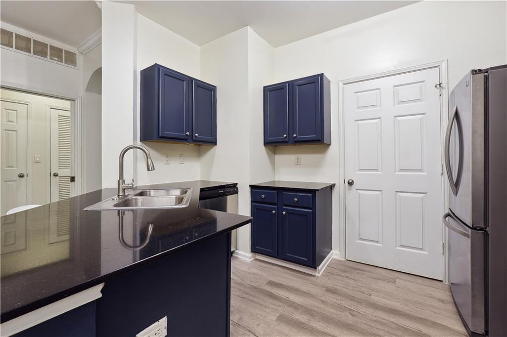 5641 Roswell Road, Unit 103 Atlanta, GA 30342 - Photo 9 of 27 a kitchen with stainless steel appliances granite countertop a refrigerator stove and sink
