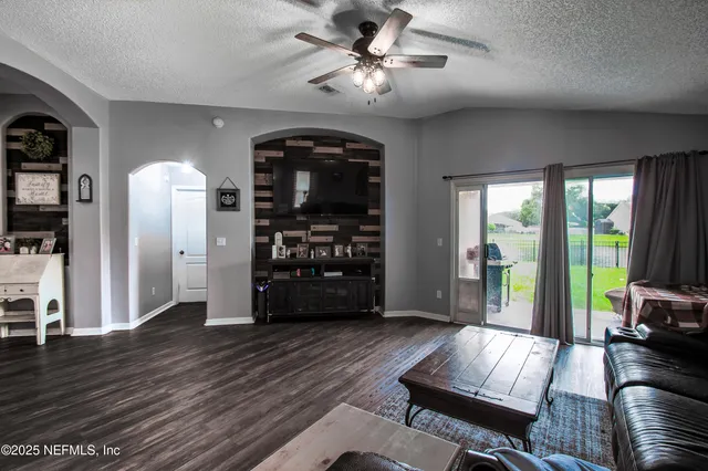 a living room with furniture and wooden floor