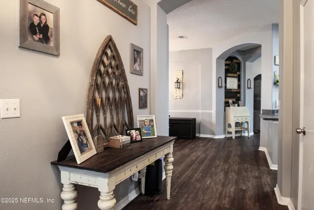 a view of an entryway with wooden floor