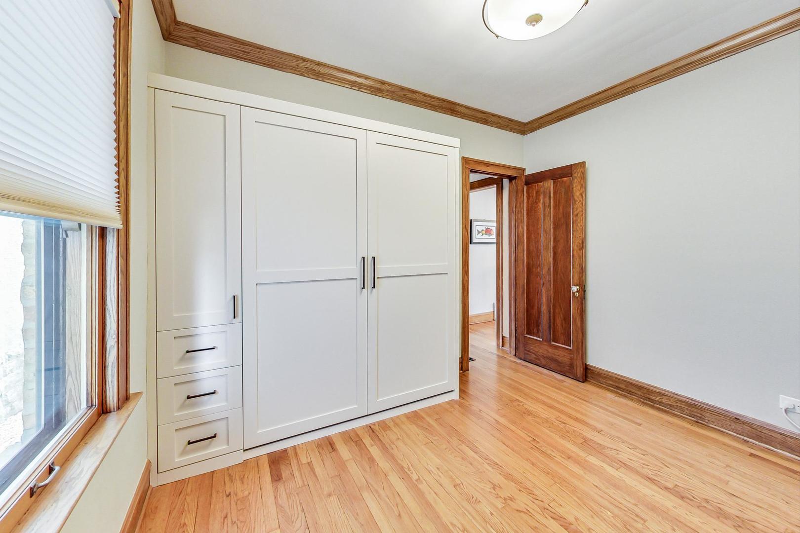 9031 Fairview Avenue Brookfield, IL 60513 - Photo 15 of 35 a view of an empty room with wooden floor and a window