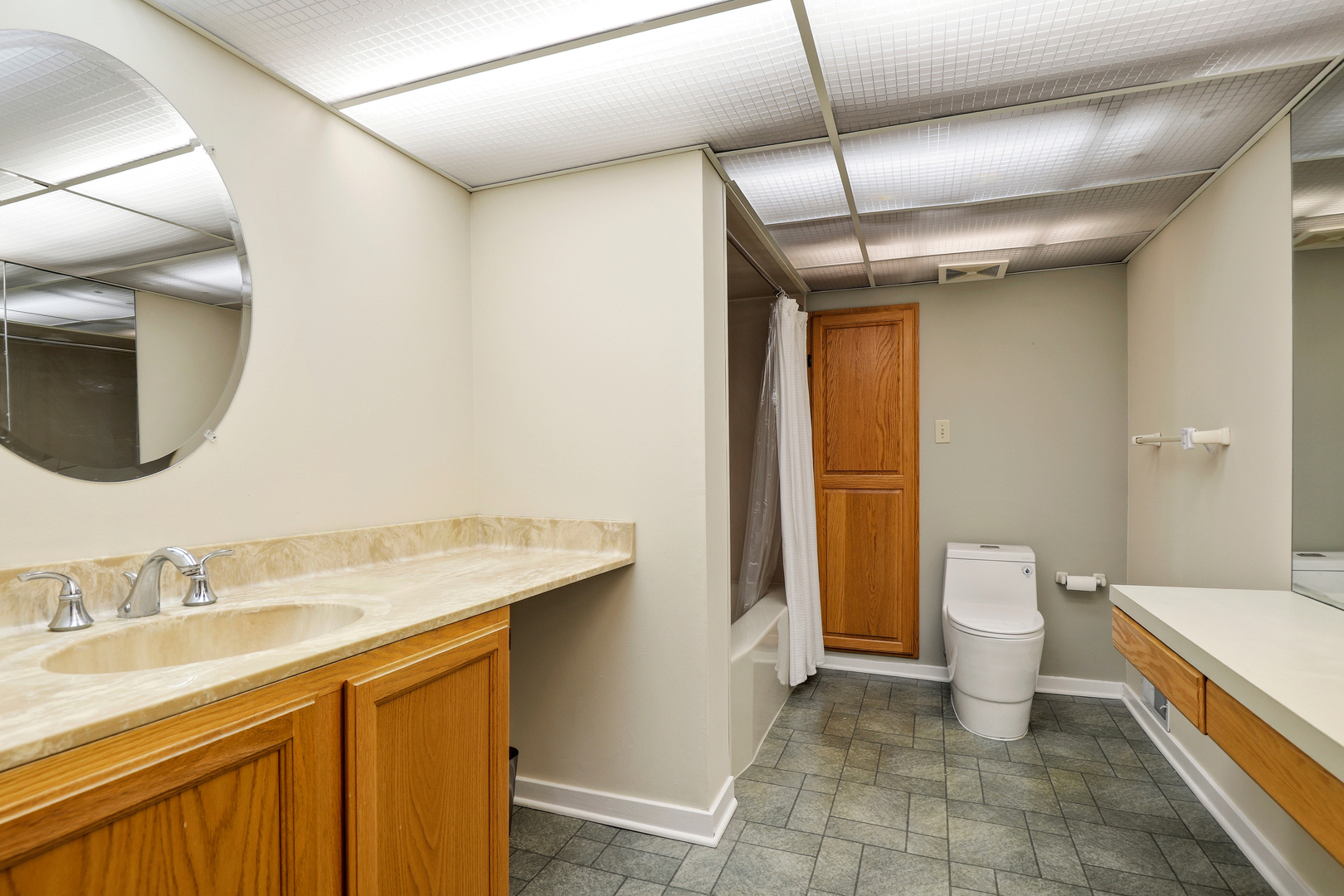 9031 Fairview Avenue Brookfield, IL 60513 - Photo 24 of 35 a bathroom with a granite countertop sink a toilet and a mirror
