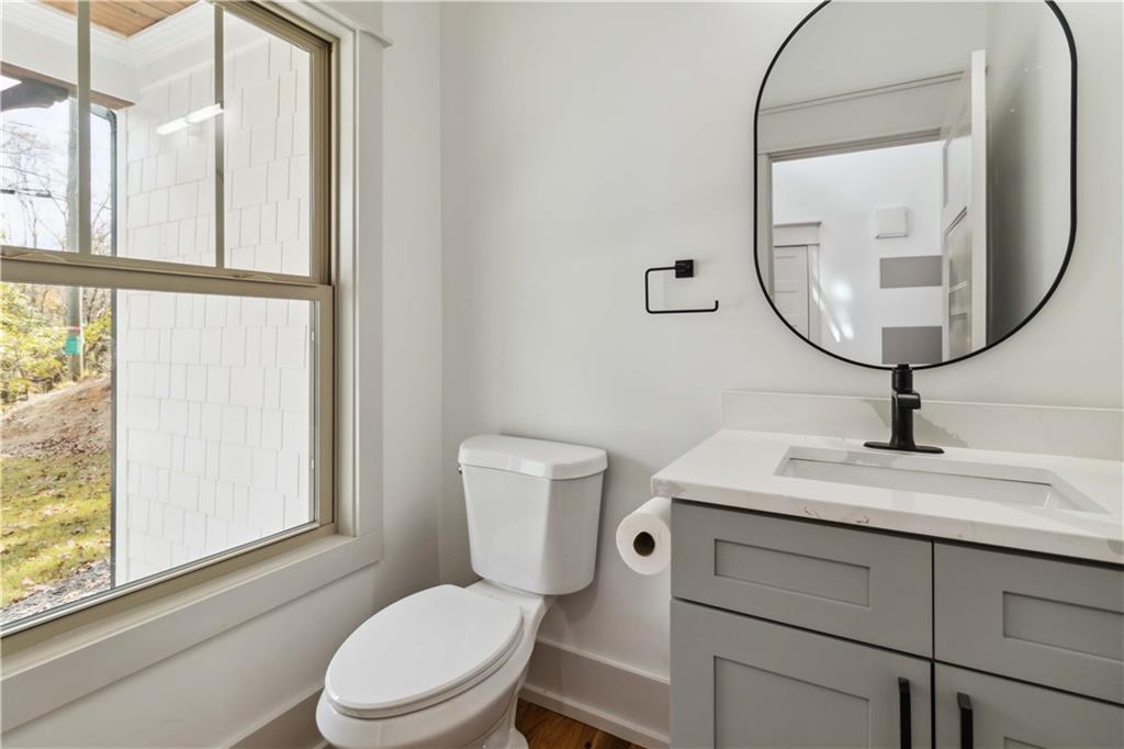 6121 Timberidge Drive Gainesville, GA 30506 - Photo 15 of 25 a bathroom with a toilet a sink and a mirror