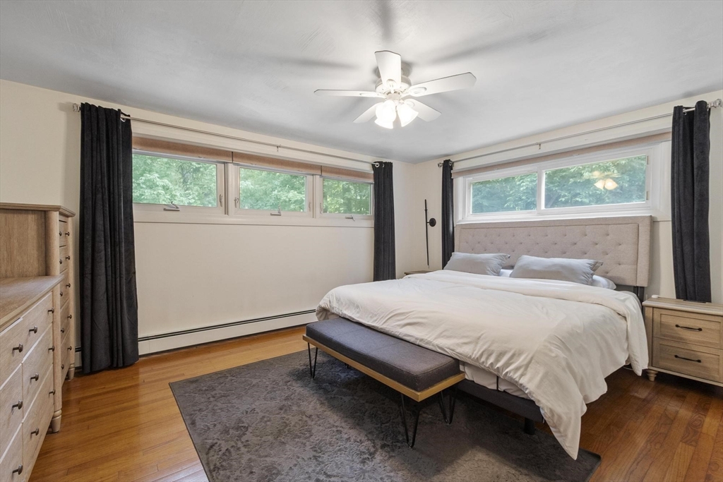 167 Gates Pond Road Berlin, MA 01503 - Photo 19 of 32 a bedroom with a bed and wooden floor
