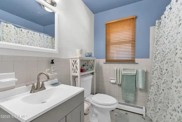 a bathroom with a sink toilet and a mirror