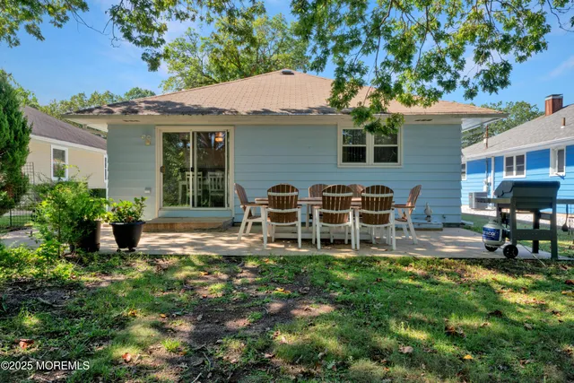 a view of a house with backyard porch and sitting area