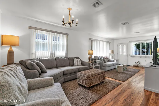a living room with furniture and a chandelier