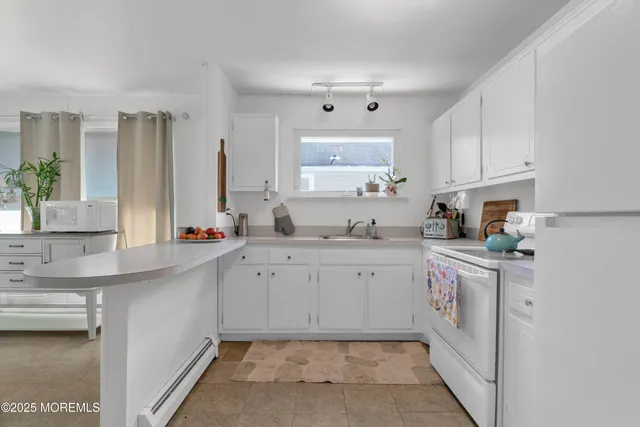 a kitchen with sink cabinets and window