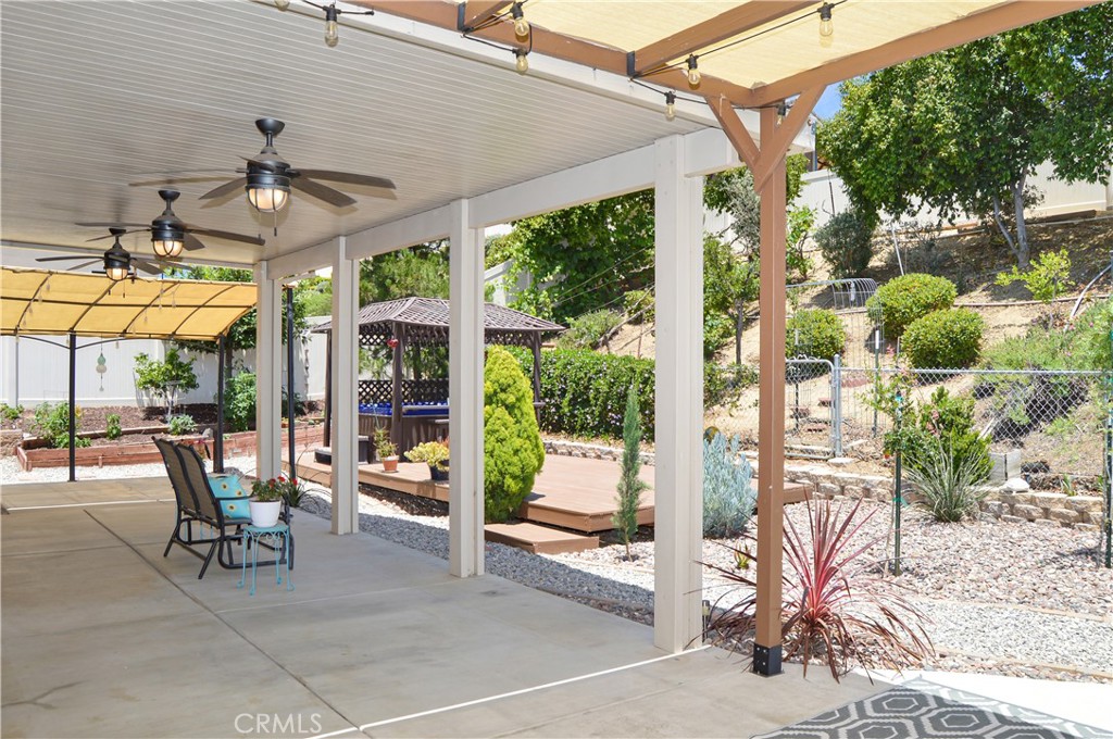 166 Fox Lane Calimesa, CA 92320 - Photo 61 of 76 Approx. 1/4-Acre Lot with Above-Ground Spa, Gazebo, Decking, Covered Patio with 3 Fans and Extra Shaded Sections, Dog Run, 3 Sheds, Fruit Trees, Grape Vines, Vegetable Garden, Bed of Irises Almost Ready to Bloom, and Gated RV Parking