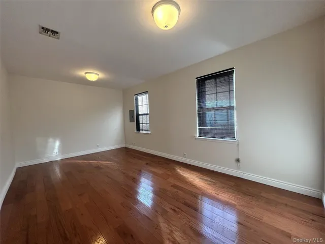 a kitchen with a sink cabinets and wooden floor