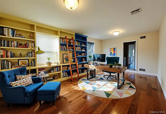 a view of walk in closet with wooden floor