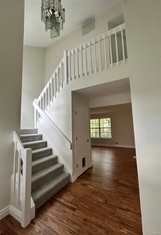 a view of a porch with a door and wooden floor