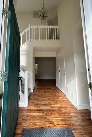 a view of entryway and hall with wooden floor