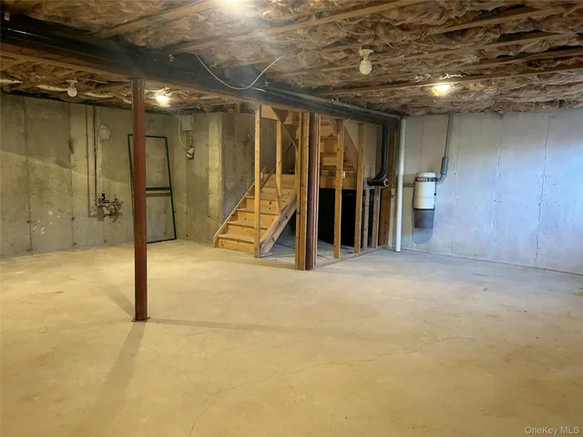 a view of an entryway wooden floor and chandelier