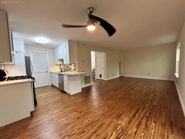 a white toilet sitting next to a sink